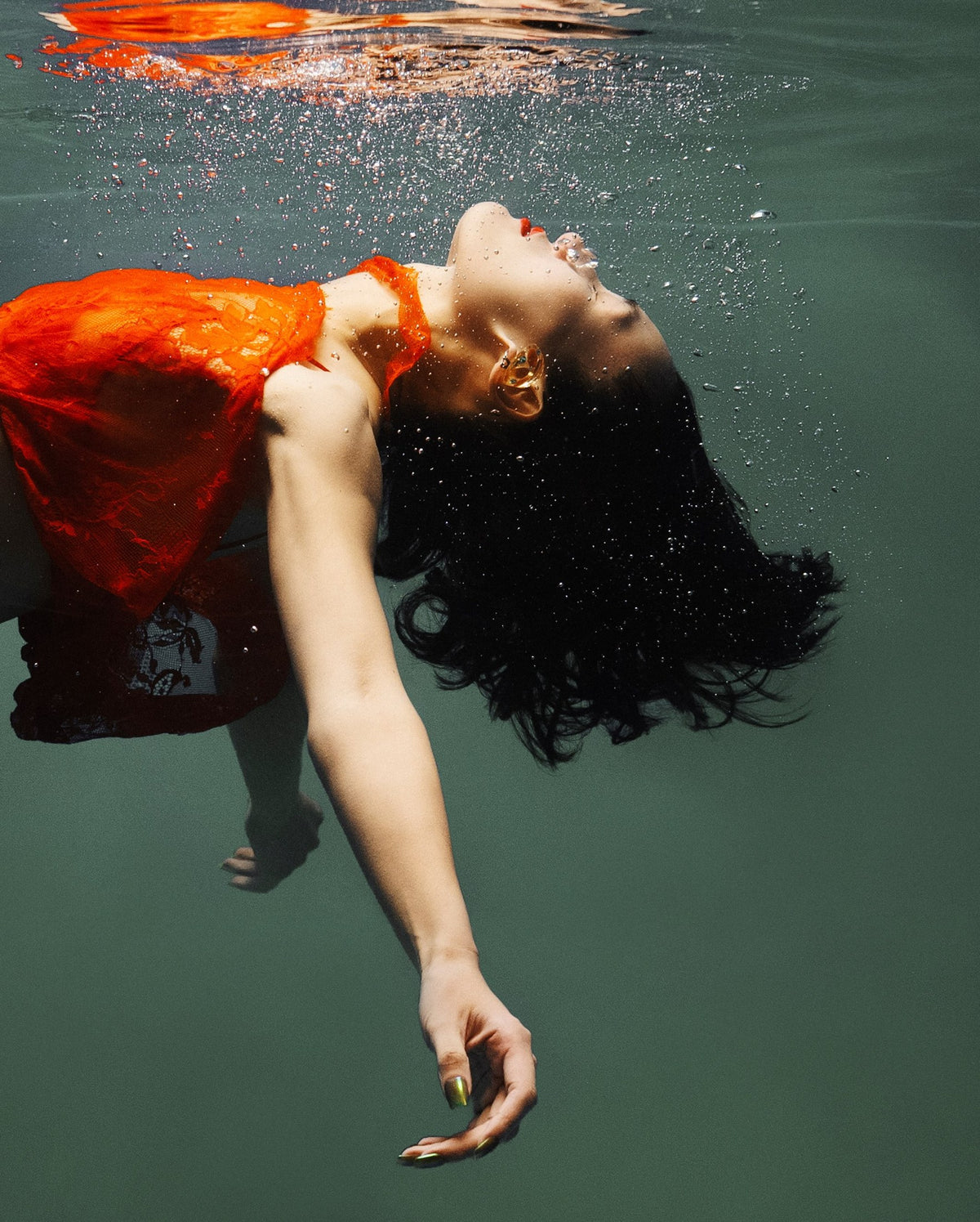 JACQUES WEI campaign: a red dress suspended in water